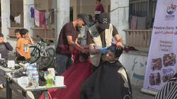 Barbers give free haircuts to displaced Gazans in Rafah - AFP