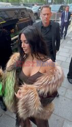 Escorted by bodyguards, Kim Kardashian and Kris Jenner make their way into the chic French restaurant Le Voltaire