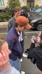 Tom Holland is seen warmly greeting fans and stopping for photos as he leaves his hotel in Paris