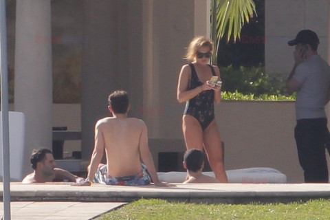 Lindsay Lohan shows off her figure in a black one piece 