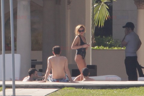 Lindsay Lohan shows off her figure in a black one piece 