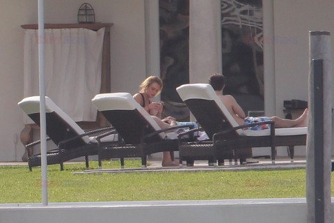 Lindsay Lohan shows off her figure in a black one piece 