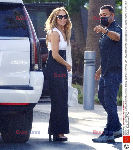 Jennifer Lopez w białym topie i czarnych spodniach