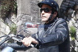 George Clooney takes a motorcycle ride to a lake in Como