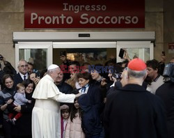 Pope Francis caresses a child as he arrives at the "Bambin Gesu'" children's hospital in Rome