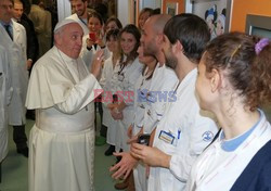 Pope Francis caresses a child as he arrives at the "Bambin Gesu'" children's hospital in Rome